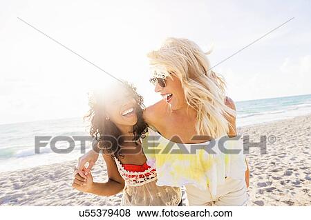 Female friends on beach View Large Photo Image Stock Photo - Female friends on beach. Fotosearch