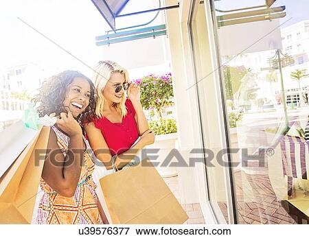 Female friends shopping View Large Photo Image Stock Photo - Female friends shopping. Fotosearch