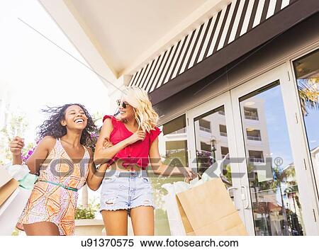 Female friends shopping View Large Photo Image Stock Photography - Female friends shopping. Fotosearch