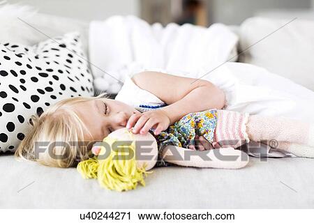 Girl (2-3) napping on sofa View Large Photo Image Stock Image - Girl (2-3) napping on sofa. Fotosearch