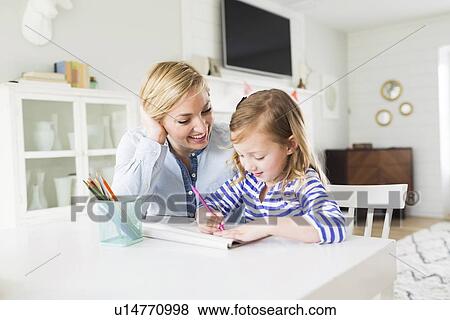 Girl (4-5) drawing with her mom View Large Photo Image Stock Photo - Girl (4-5) drawing with her mom. Fotosearch