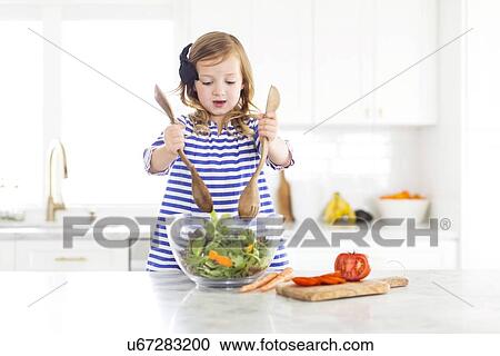 Girl (4-5) mixing salad View Large Photo Image Stock Image - Girl (4-5) mixing salad. Fotosearch