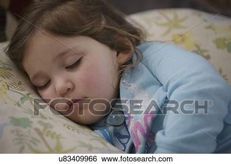 Girl sleeping in bed View Large Photo Image Stock Photograph - Girl sleeping in bed. Fotosearch