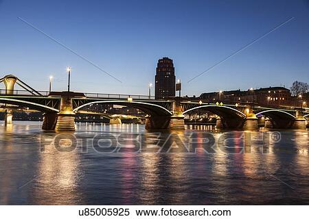 Stock Photography - Ignatz-Bubis Bridge illuminated at dusk. Fotosearch