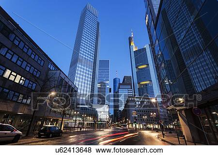 Stock Photo - Illuminated city street with skyscrapers. Fotosearch