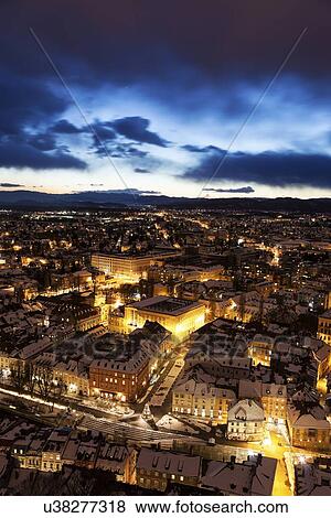 Stock Photo - Illuminated cityscape at dusk. Fotosearch
