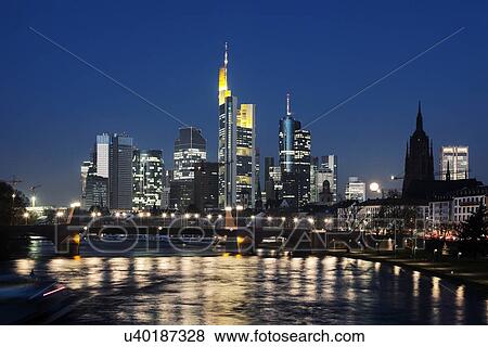 Stock Photo - Illuminated riverfront skyline. Fotosearch