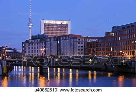 Stock Image - Illuminated riverfront skyline with television tower. Fotosearch