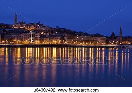 Stock Image - Illuminated skyline reflecting in Danube River. Fotosearch