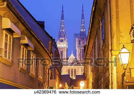 Stock Photograph - Illuminated street and spires of Zagreb Cathedral. Fotosearch