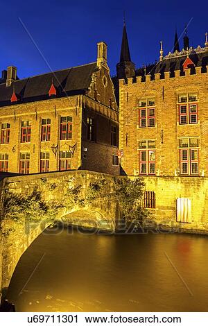Stock Image - Illuminated townhouses and bridge. Fotosearch