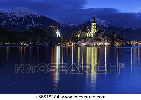 Lake Bled and illuminated Church of the Assumption View Large Photo Image Picture - Lake Bled and illuminated Church of the Assumption. Fotosearch