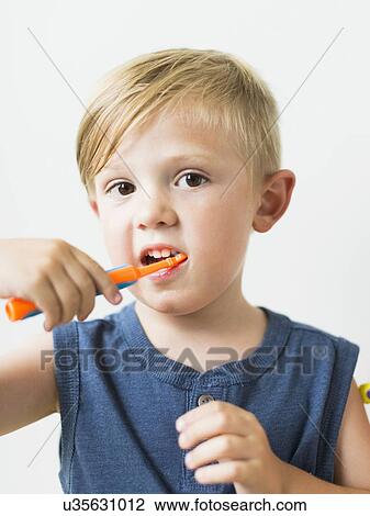 Stock Image - Little boy (2-3) brushing teeth. Fotosearch