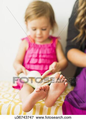 Little girl (2-3) holding book View Large Photo Image Stock Photo - Little girl (2-3) holding book. Fotosearch