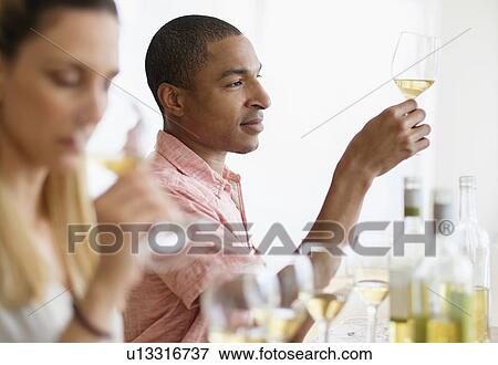 Man and woman tasting white wine View Large Photo Image Stock Photo - Man and woman tasting white wine. Fotosearch