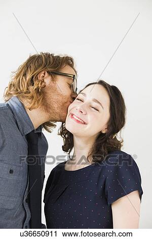 Man kissing smiling young woman View Large Photo Image Stock Image - Man kissing smiling young woman. Fotosearch