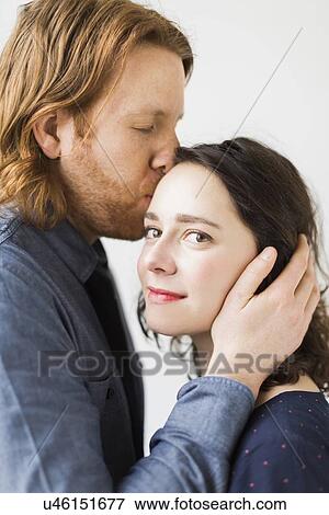 Man kissing young woman View Large Photo Image Stock Photo - Man kissing young woman. Fotosearch