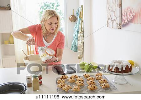 Mature woman baking in kitchen View Large Photo Image Stock Photograph - Mature woman baking in kitchen. Fotosearch
