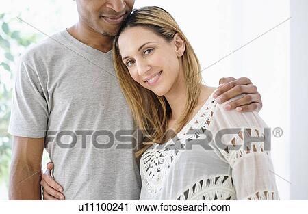 Stock Image - Mid adult couple embracing. Fotosearch