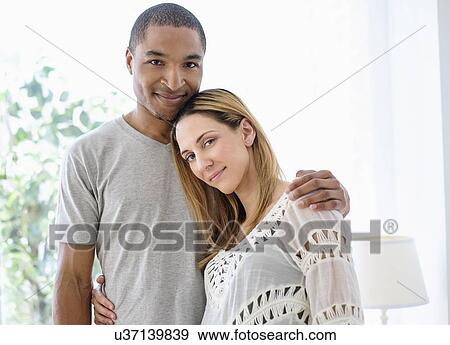 Stock Photo - Mid adult couple embracing. Fotosearch