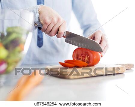 Picture - Mid-adult woman preparing salad. Fotosearch