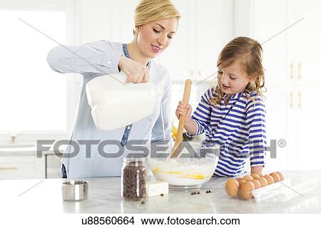 Mother and daughter (4-5) baking View Large Photo Image Picture - Mother and daughter (4-5) baking. Fotosearch