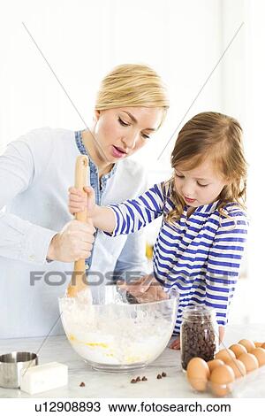 Mother and daughter (4-5) baking View Large Photo Image Stock Image - Mother and daughter (4-5) baking. Fotosearch