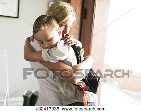 Stock Photography - Mother hugging son (6-7). Fotosearch