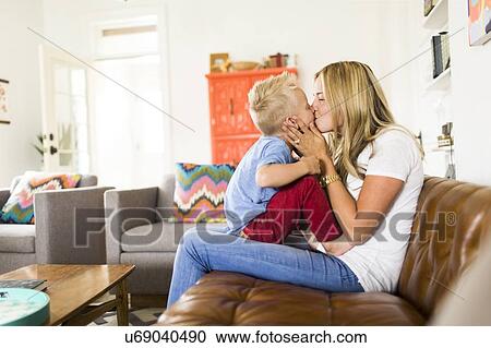 Mother kissing son (4-5) on sofa View Large Photo Image Stock Image - Mother kissing son (4-5) on sofa. Fotosearch