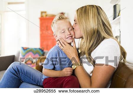 Stock Photography - Mother kissing son (4-5) . Fotosearch