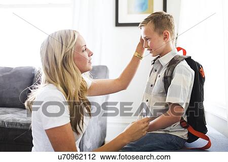 Mother preparing son (6-7) for school View Large Photo Image Stock Image - Mother preparing son (6-7) for school. Fotosearch