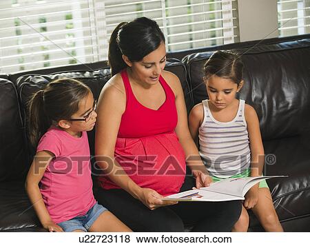 Mother reading to children (6-7, 8-9) View Large Photo Image Stock Photo - Mother reading to children (6-7, 8-9) . Fotosearch