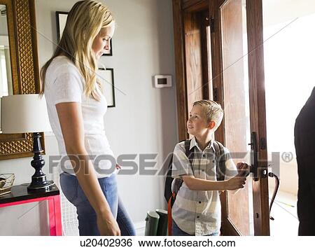 Mother watching son (6-7) leaving for school View Large Photo Image Stock Photograph - Mother watching son (6-7) leaving for school. Fotosearch