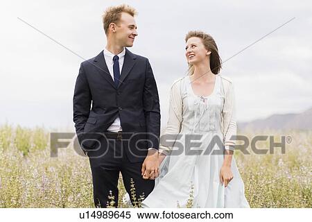 Stock Photography - Newlywed couple in field . Fotosearch