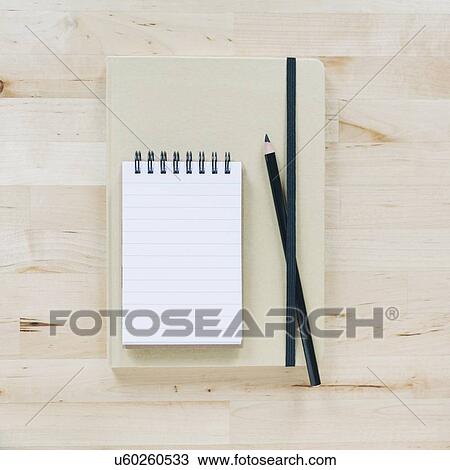 Stock Image - Overhead view of notebooks. Fotosearch