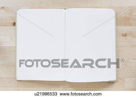 Stock Image - Overhead view of opened notebooks. Fotosearch