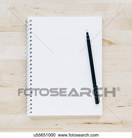 Stock Image - Overhead view of pen on notebook. Fotosearch