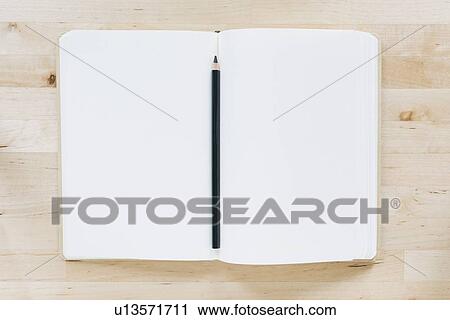 Overhead view of pencil in notebook View Large Photo Image Stock Image - Overhead view of pencil in notebook. Fotosearch