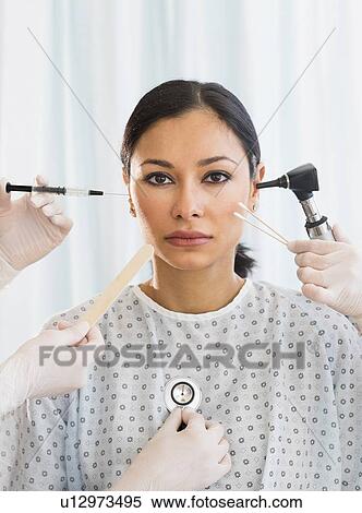 Patient being examined using medical instruments View Large Photo Image Stock Photography - Patient being examined using medical instruments. Fotosearch