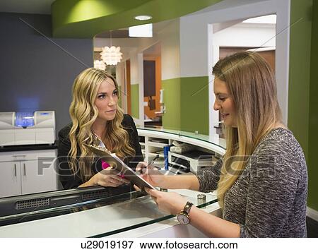 Patient talking to receptionist View Large Photo Image Stock Photo - Patient talking to receptionist. Fotosearch