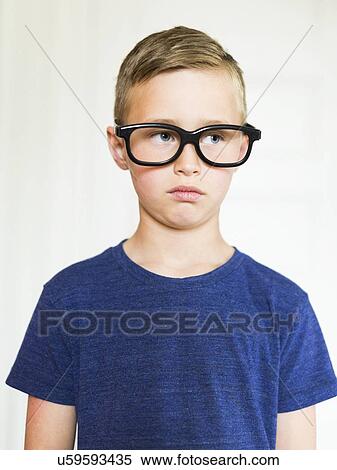 Stock Photography - Portrait of boy (6-7) wearing eyeglasses. Fotosearch