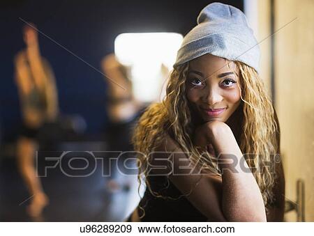 Stock Photo - Portrait of female dancer with friends in background. Fotosearch