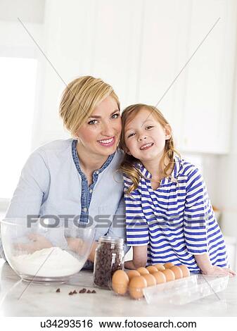 Portrait of girl (4-5) spending time with mom in kitchen View Large Photo Image Stock Photograph - Portrait of girl (4-5) spending time with mom in kitchen. Fotosearch