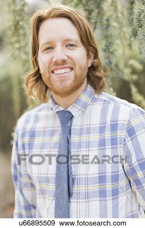 Portrait of smiling man wearing plaid shirt View Large Photo Image Stock Photo - Portrait of smiling man wearing plaid shirt. Fotosearch