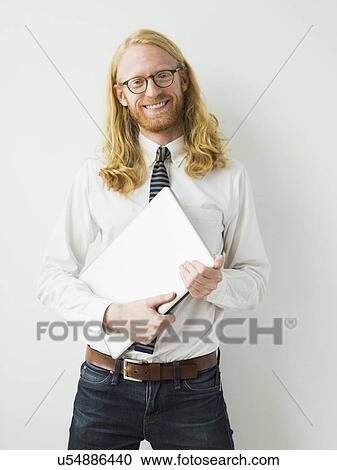 Portrait of smiling man with laptop View Large Photo Image Stock Image - Portrait of smiling man with laptop. Fotosearch