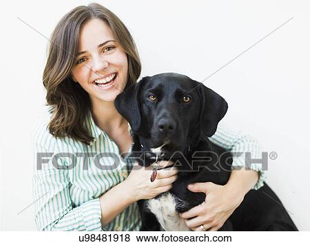 Stock Photo - Portrait of smiling woman with dog. Fotosearch