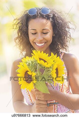 Portrait of smiling woman with sunflowers View Large Photo Image Stock Image - Portrait of smiling woman with sunflowers. Fotosearch