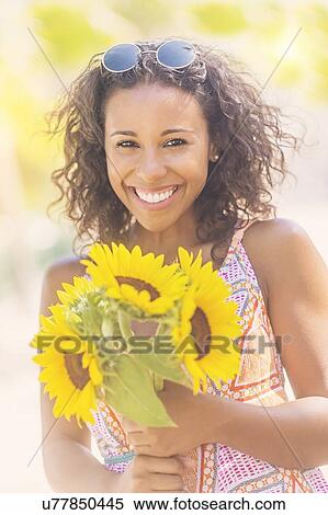 Portrait of smiling woman with sunflowers View Large Photo Image Stock Photography - Portrait of smiling woman with sunflowers. Fotosearch