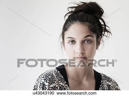 Stock Image - Portrait of teenage girl (14-15) in studio. Fotosearch