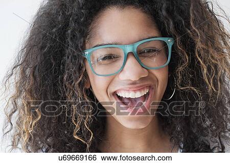 Portrait of teenage girl (16-17) wearing eyeglasses View Large Photo Image Stock Photograph - Portrait of teenage girl (16-17) wearing eyeglasses. Fotosearch